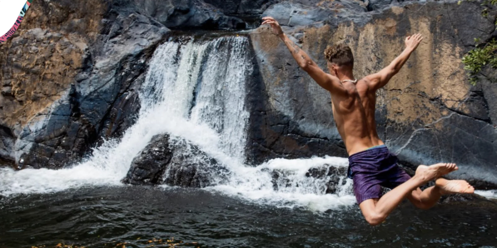 Flying through the air at El Zumbón, a waterfall and natural pool area located in Tonosí, Los Santos Province, Panama.