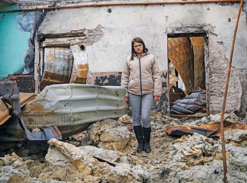 A woman stands in a bombed-out building in Pokrovsk Town in the Donetsk region of Ukraine. © UNOCHA.