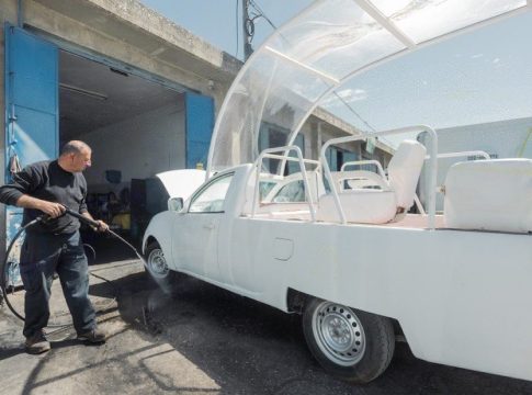 Men work on turning the popemobile into a health clinic. Photo credit: Caritas / Vatican.