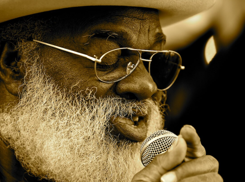 Grandpa Elliot Small (1944-2022) was a veteran street-musician in New Orleans who played the harmonica, sang, and was a street icon in New Orleans. He was a regular with 'Playing for Change.' Photo credit: Wikipedia.