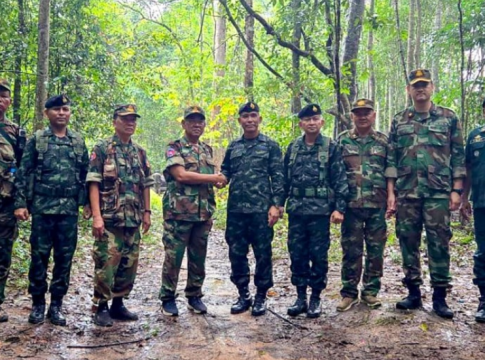 Representatives of the Royal Thai Army and the Royal Cambodian Army shake hands during military talks near the disputed border between their countries on June 8.