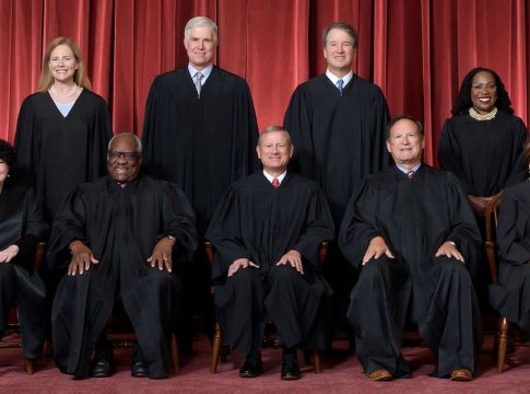 Formal group photograph of the Supreme Court as it was been comprised on June 30, 2022 after Justice Ketanji Brown Jackson joined the Court.  The Justices are posed in front of red velvet drapes and arranged by seniority, with five seated and four standing.

Seated from left are Justices Sonia Sotomayor, Clarence Thomas, Chief Justice John G. Roberts, Jr., and Justices Samuel A. Alito and Elena Kagan.  
Standing from left are Justices Amy Coney Barrett, Neil M. Gorsuch, Brett M. Kavanaugh, and Ketanji Brown Jackson.

Credit: Fred Schilling, Collection of the Supreme Court of the United States