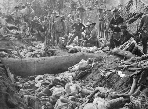 Photo U.S. troops posing with of massacred Filipinos, March 8, 1906 at Bud Dajo, Philippines. Photo credit: John R. White Papers, Knight Library, University of Oregon / New Lines Magazine.