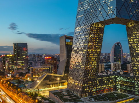 the China Central Television (CCTV) Headquarters in Beijing, China, at dusk. This iconic skyscraper is known for its distinctive angular loop shape.