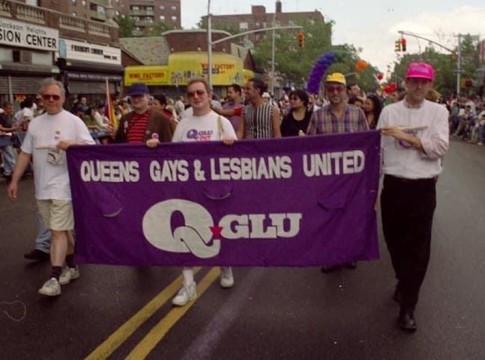 Activists, including author (right, pink hat) proudly carried the Q-GLU banner. Photo credit: Jim Luce.