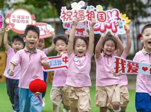 Children run with blessing signs in hand at a kindergarten in Xinghua City, east China's Jiangsu Province. Photo credit: Zhou Shegen / Xinhua.