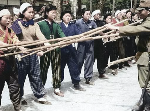 A Japanese soldier trains women to defend the homeland with bamboo spears in 1945. Bushido, or "the way of the warrior," was a code deeply ingrained not only in the military but also in Japan's citizenry. Photo credit: Imperial Japanese Army. Recolored.
